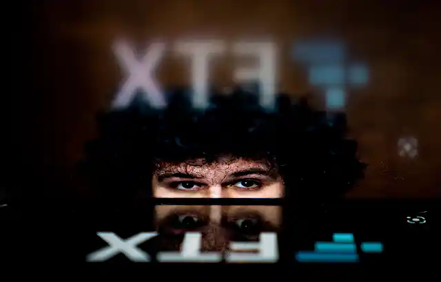 Eyes of young man with black curly hair.