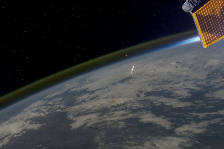 A shooting star and airglow as seen from the International Space Station.
