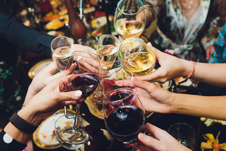 Group of people clinking glasses of wine