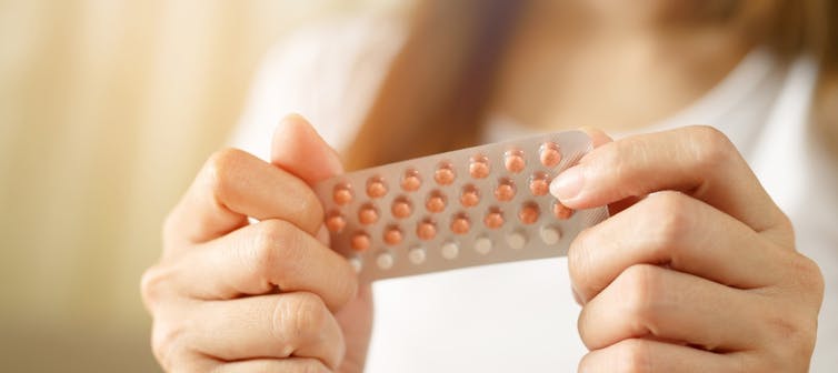 Woman holding pack of contraceptive pills