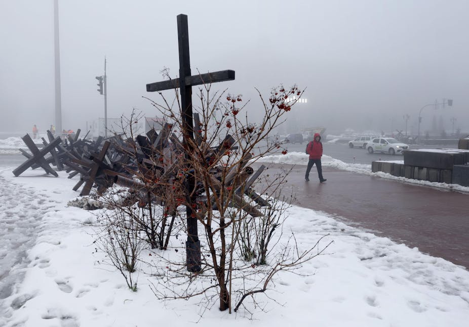 A cross in the snow on a street in Kyiv, Ukraine, December 2022.