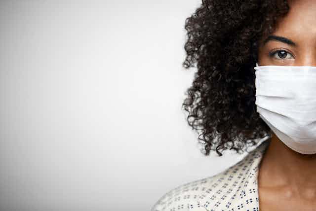 Photo of a young African-American woman wearing an N-95 face mask.