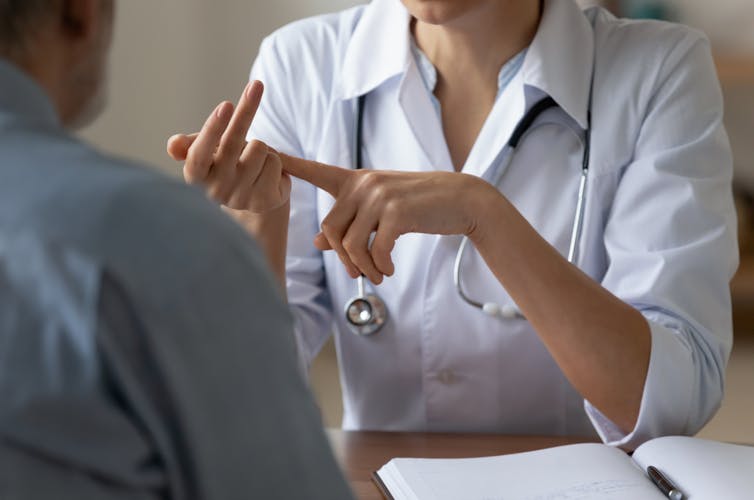 Doctor with stethoscope around neck talking to patient