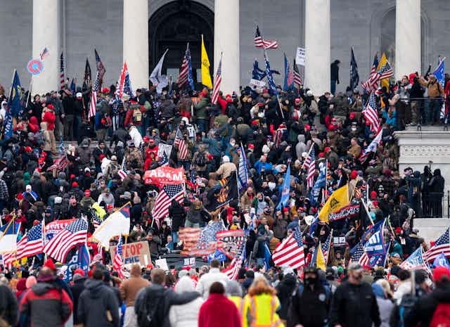 Thousands of people crowd on the steps of the U.S. Capitol.