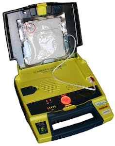 An open yellow box with wired and a red button.