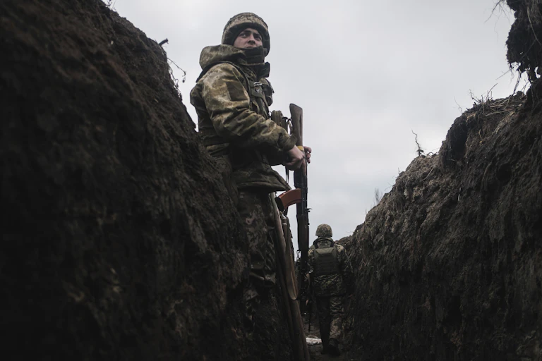 A Ukrainian soldier stands on sentry duty in a trench in Bakhmut, eastern Ukraine.