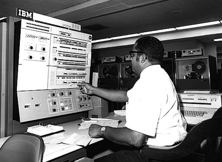Man operating early computer