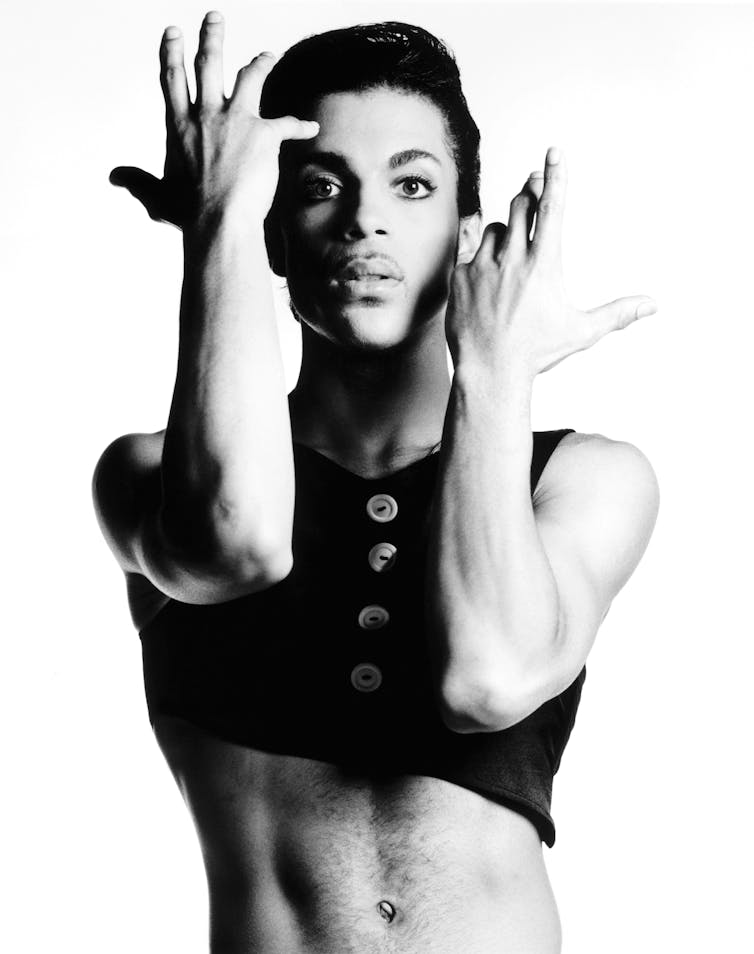 Pop artist Prince voguing for a black and white photo.