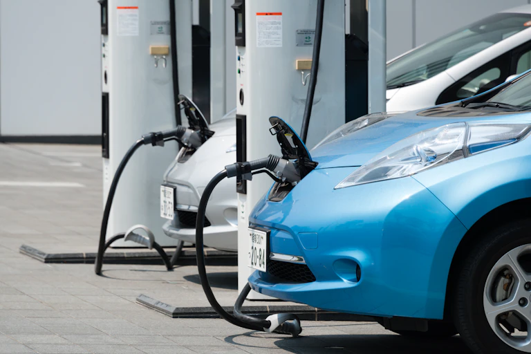 Two electric vehicles plugged into charging stations