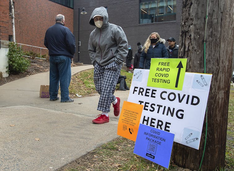 People seen coming to and from a COVID-19 testing site.