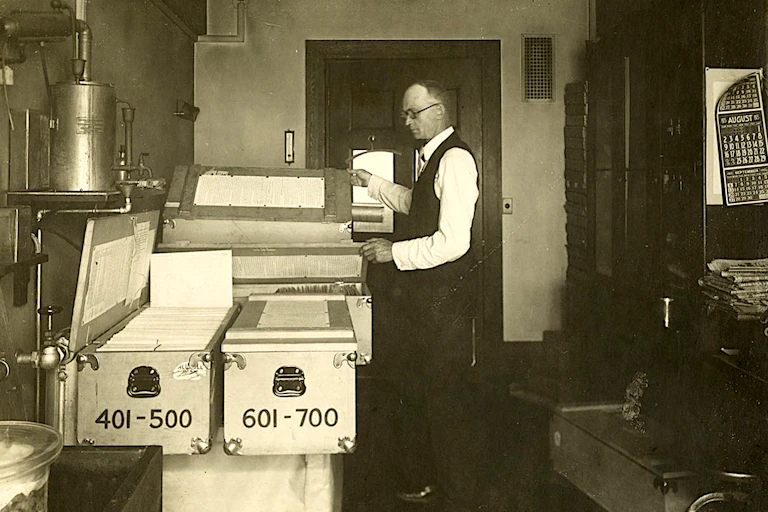 Man with office full of health data cards