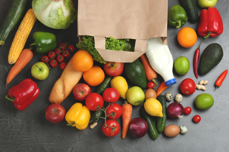 A bag of groceries spread out over a table