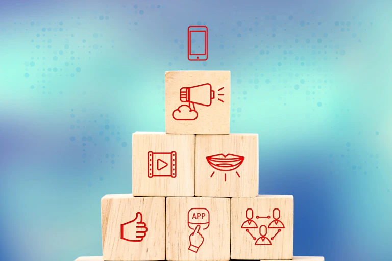 Wooden blocks stacked in a pyramid with icons representing actions carried out on the internet, such as liking, clicking and sharing.