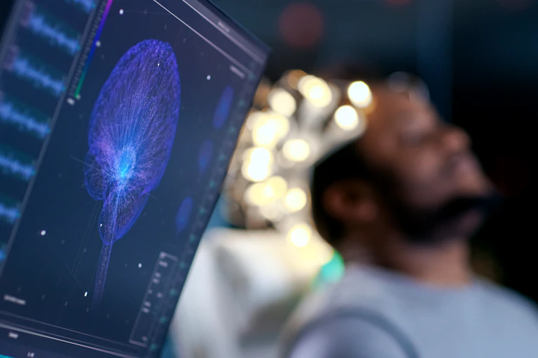 A man lying down has an EEG