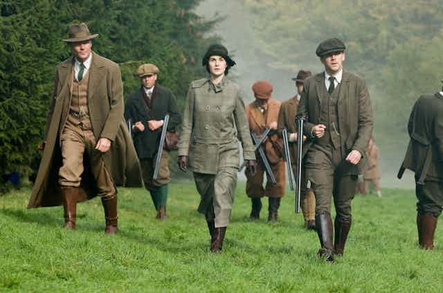 A group of upper crust types on a shoot in the country.