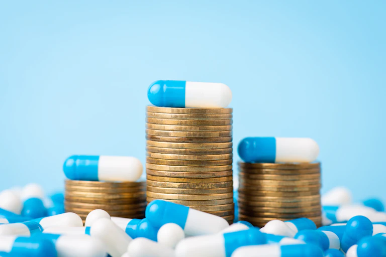 Stacks of coins with pill capsules on them