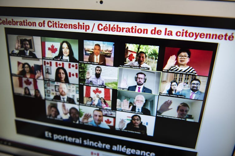 People take the oath of Canadian citizenship in a virtual ceremony seen on a computer screen.