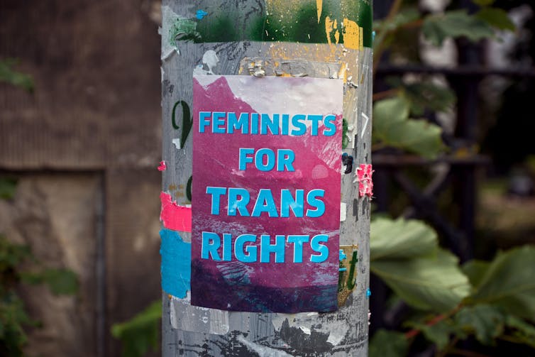 A sticker reading 'feminists for trans rights' on a post in Edinburgh