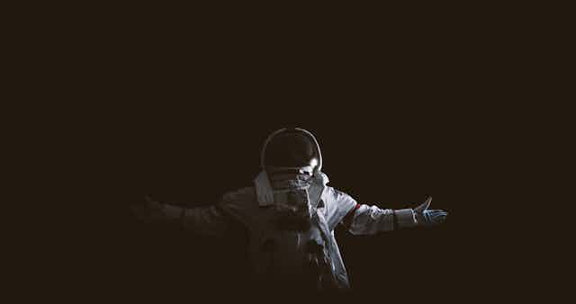 Astronaut against black background