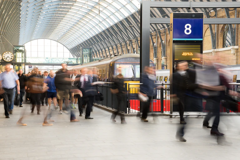 London train station. Blur of people moving in rush hour at King's Cross station, England, UK.