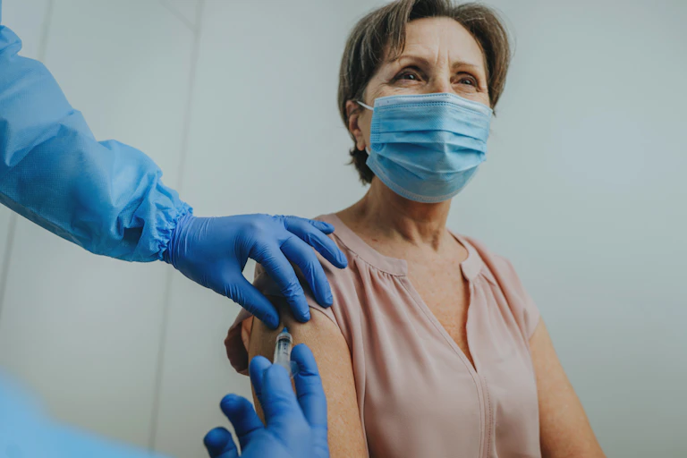 A woman receives a vaccination.