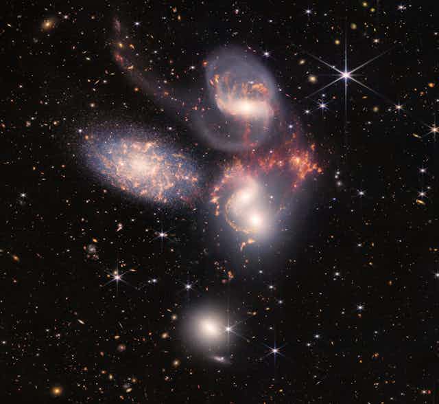 Five large galaxies against a backdrop of stars and smaller galaxies.