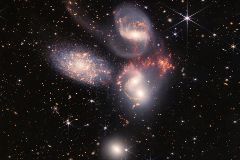 Five large galaxies against a backdrop of stars and smaller galaxies.