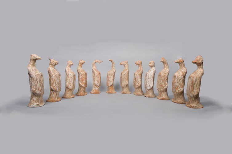 Twelve ceramic figures with human bodies and animal heads