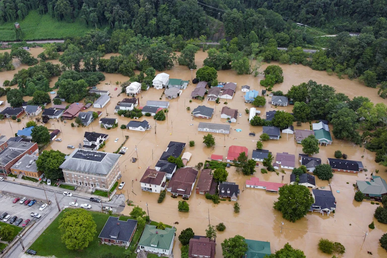 A community with houses and buildings surrounded by water.