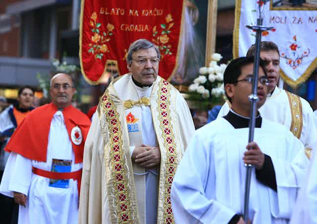 George Pell wears robes at a Catholic ceremony.
