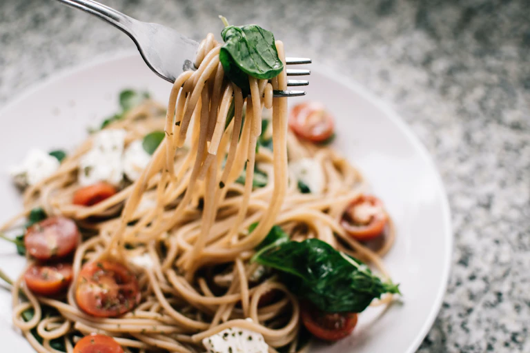 fork lifting pasta from plate