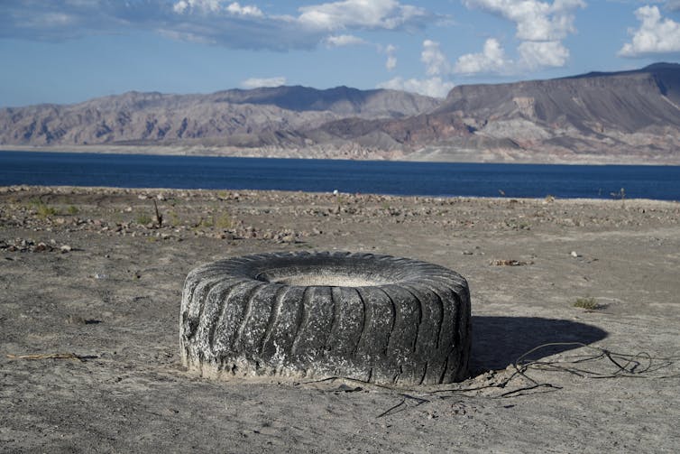 A tyre sits on a dry lake bed