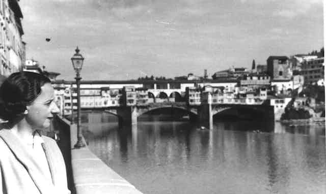 Mujer mirando al río en Florencia.
