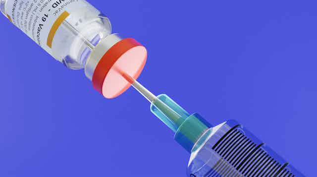 An illustration of a COVID vaccine being drawn up.