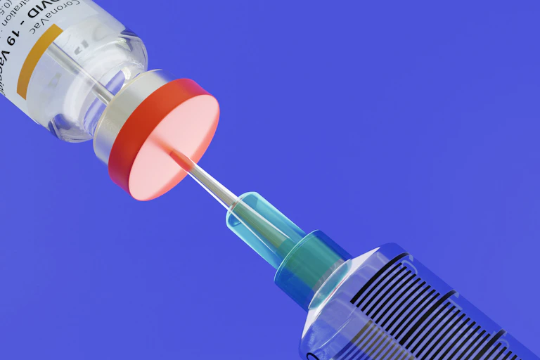 An illustration of a COVID vaccine being drawn up.