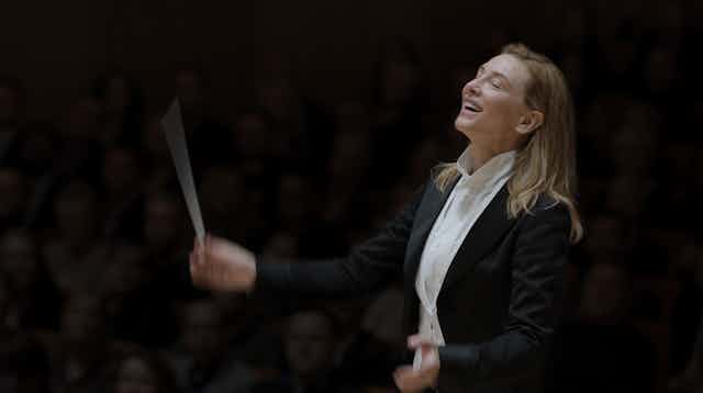 A woman conducting. 
