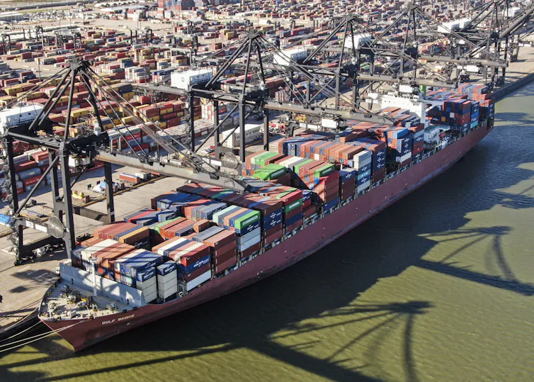 An aerial photo of a container ship docked at the Port of Houston.