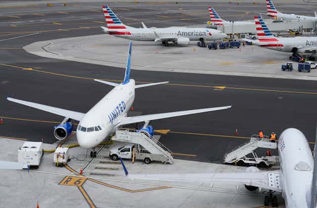 Planes sitting at gates.