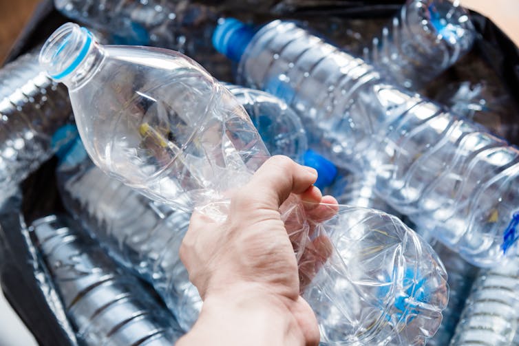 Plastic water bottle scrunched in a hand