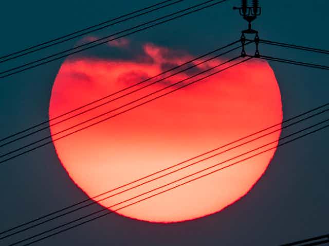 Setting sun with cables in front