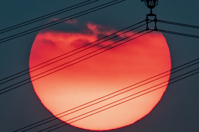 Setting sun with cables in front