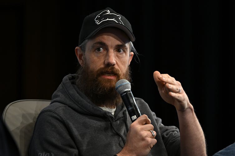 Mike Cannon-Brookes talking into a microphone