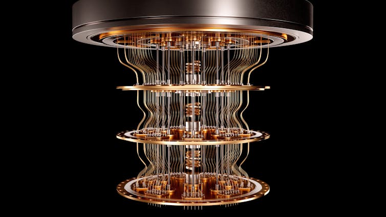 An elaborate cooling rig for a quantum computer, against a black background.