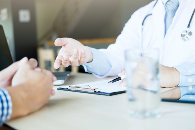 Patient and doctor talking across desk