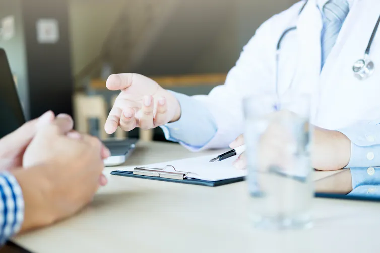 Patient and doctor talking across desk