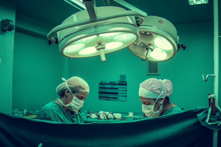 wo surgeons operating behind a screen