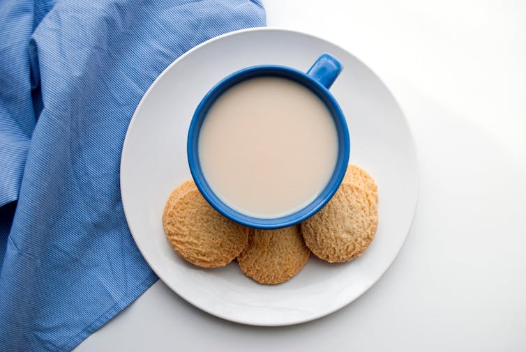 A plate of shortbread biscuits with milky tea.