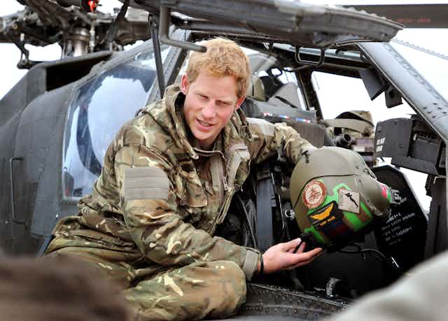 2012 photo of Prince Harry making pre-flight checks on a helicopter in Afghanistan during his military service
