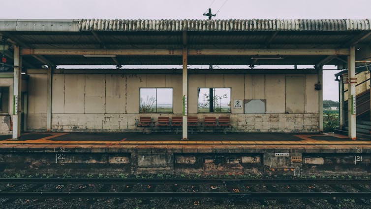 An empty, run-down train station platform.