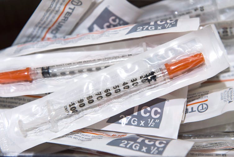 Syringes in plastic wrapping.